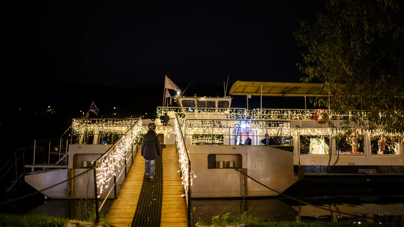 An illuminated sightseeing boat on the Vltava at night