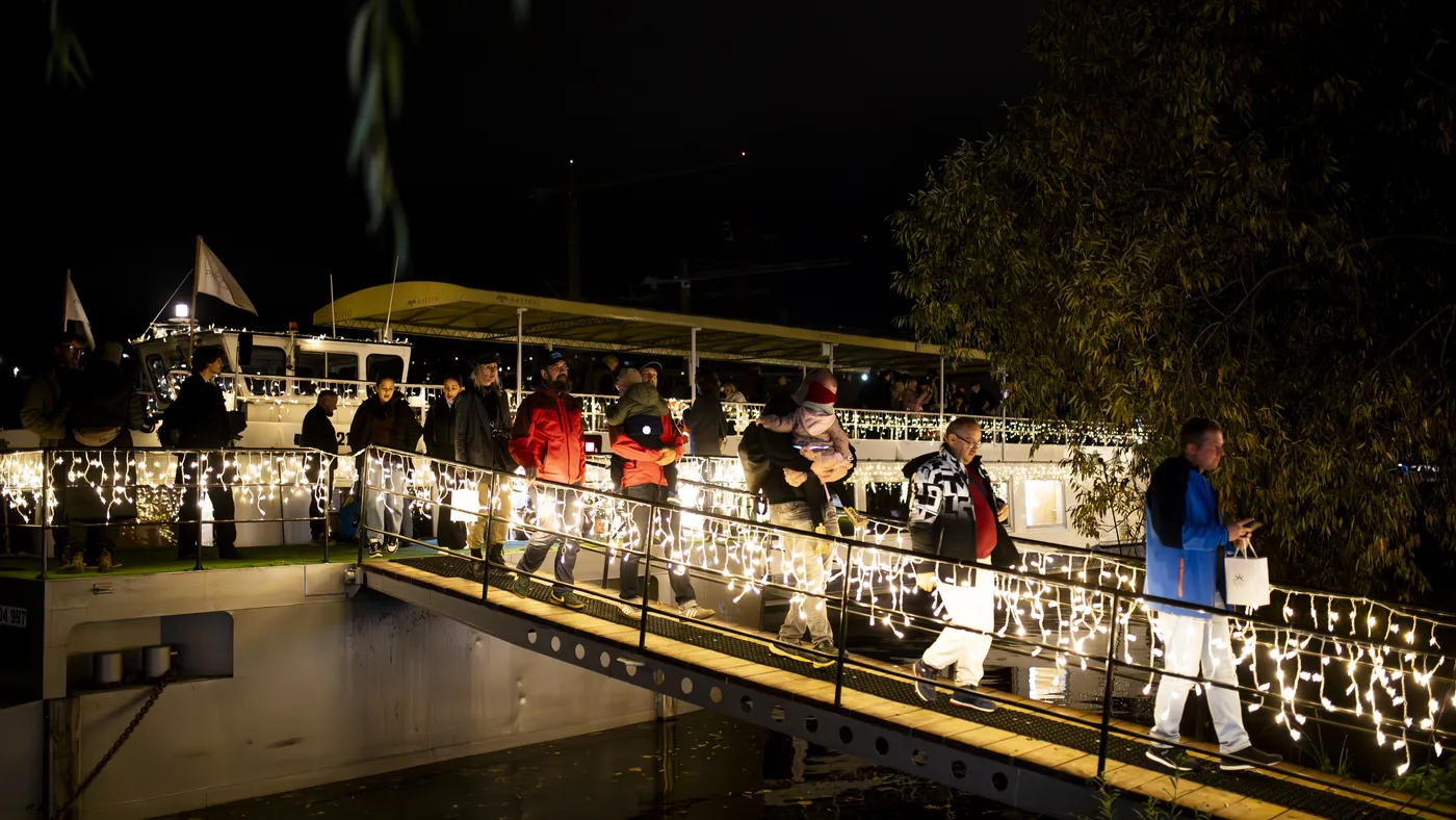 An illuminated sightseeing boat on the Vltava at night