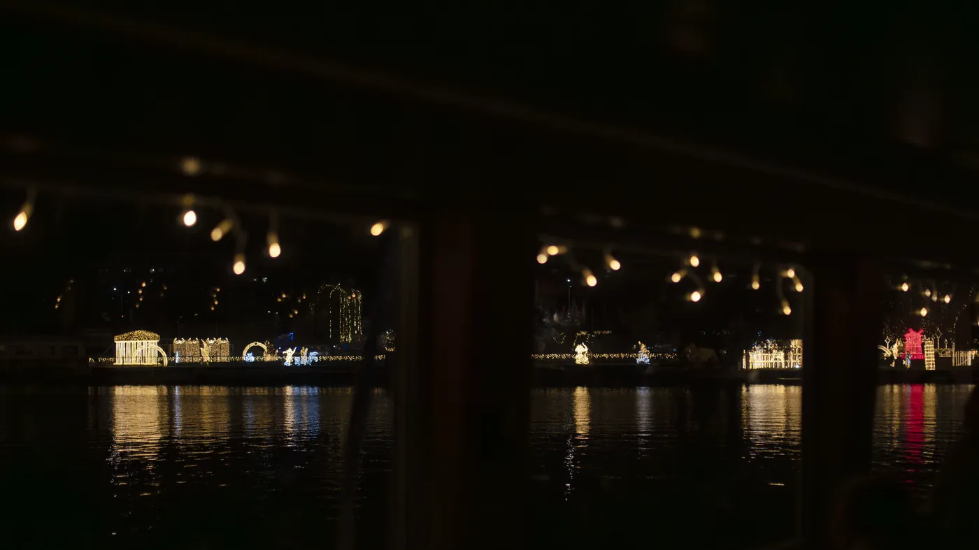 An illuminated sightseeing boat on the Vltava at night